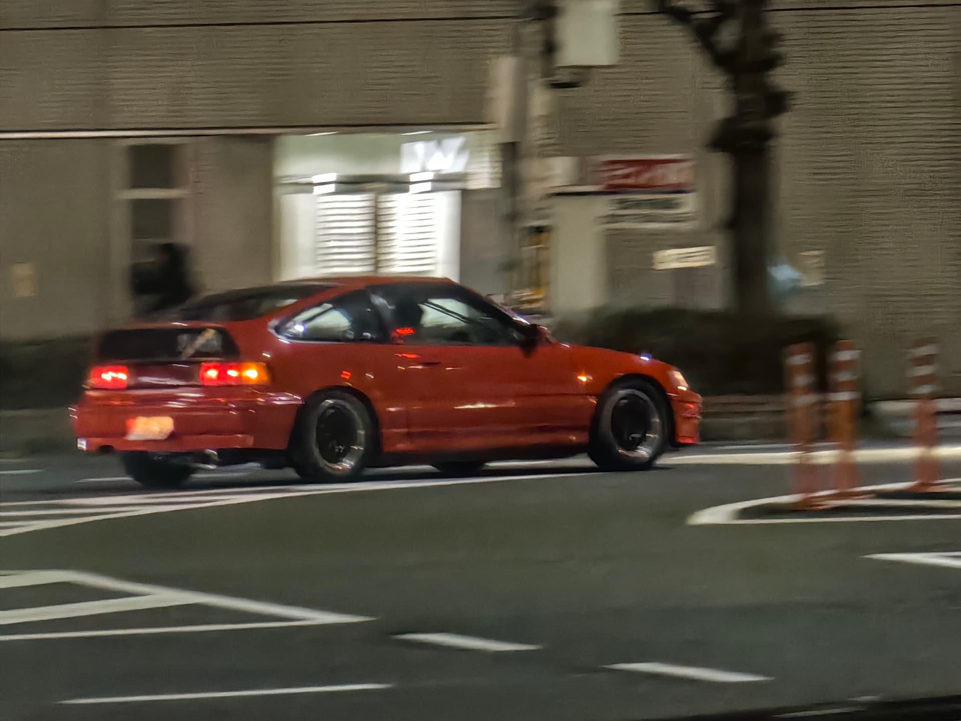Orange sports car at night